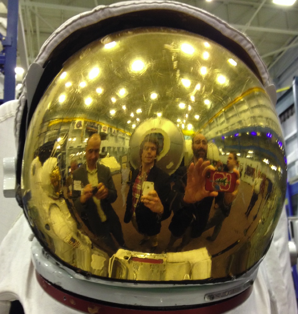 Reflected in the gold visor of an astronaut helmet